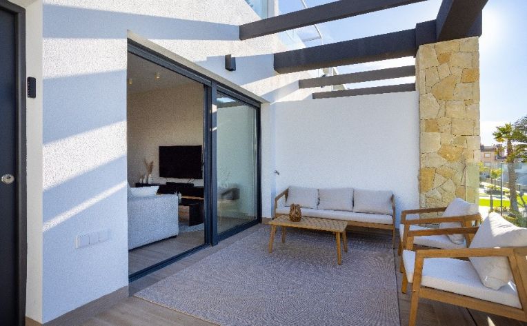 Covered patio room with seating, stone, and slats